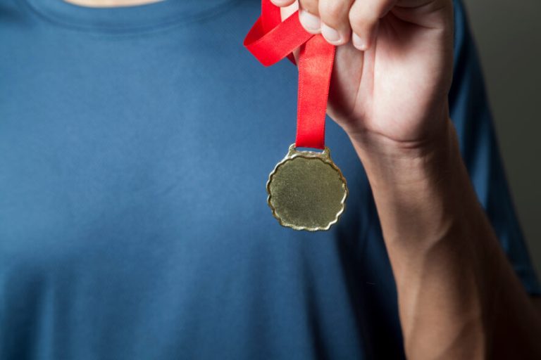 Athlete,Holding,Gold,Medal,With,His,Hands.,Medal,Concept.