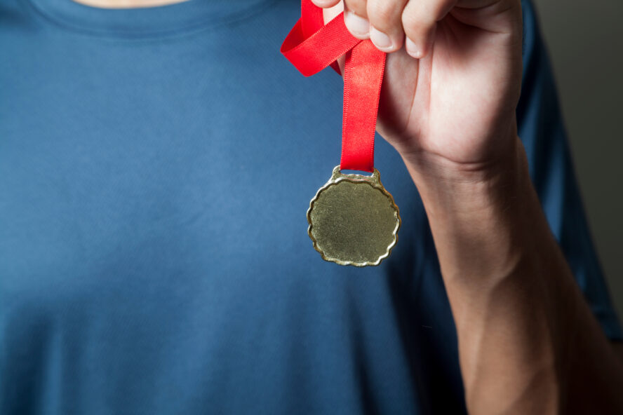 Athlete,Holding,Gold,Medal,With,His,Hands.,Medal,Concept.